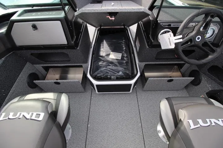 Slide: The Image of 2025 Lund 1775 Impact XS Sport boat interior with storage compartments and seating. - 2
