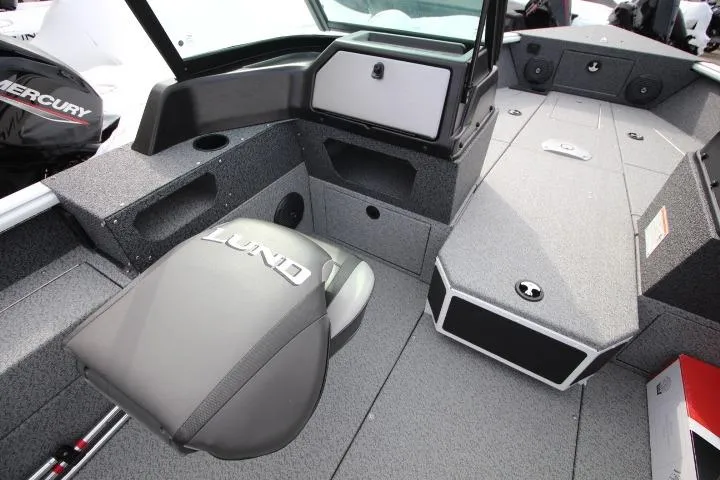 Slide: The Image of 2025 Lund 1775 Impact XS Sport boat interior with seating and storage compartments. - 3