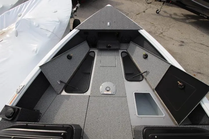 Slide: The Image of 2025 Lund 1775 Impact XS Sport boat interior with open storage compartments. - 4