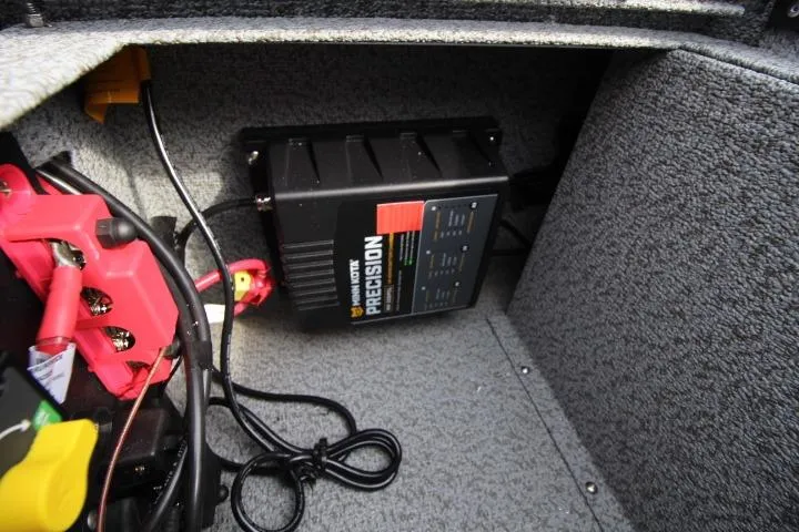 Slide: The Image of 2025 Lund 1775 Impact XS Sport boat interior with battery charger and wiring. - 6
