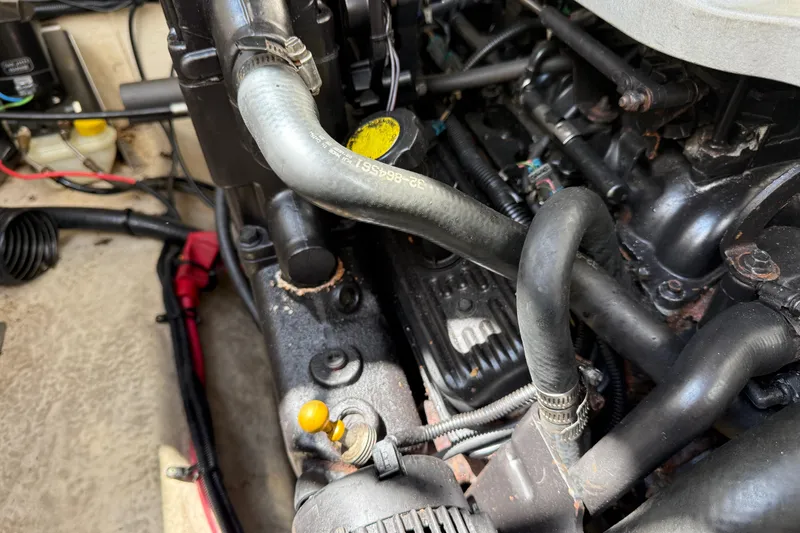 Slide: The Image of Engine compartment of a 2010 Sea Ray 240 Sundancer boat, showing hoses and components. - 29