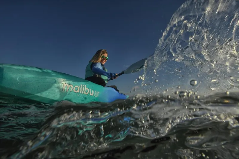 Slide: The Image of Person kayaking on Ocean Kayak Malibu 9.5, 2023 model, splashing water. - 2