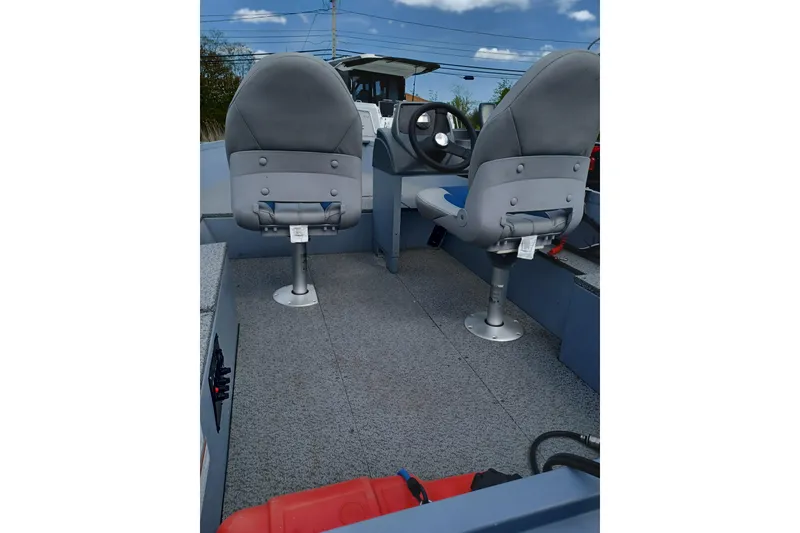 Slide: The Image of Interior of 2021 G3 Guide V150 T boat with two gray seats and steering console. - 10