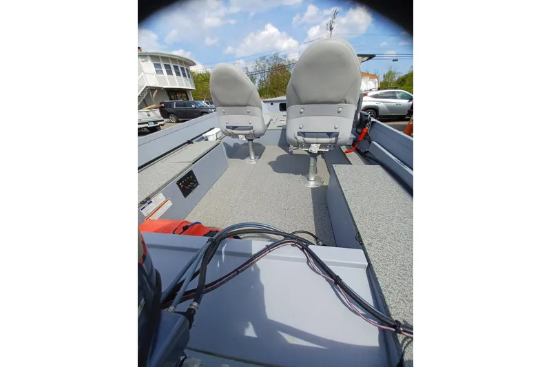Slide: The Image of 2021 G3 Guide V150 T boat interior with two seats and control cables. - 11