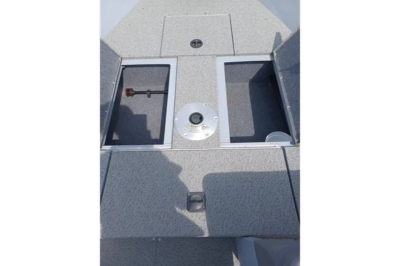 Slide: The Image of 2021 G3 Guide V150 T boat interior with open storage compartments and textured flooring. - 13
