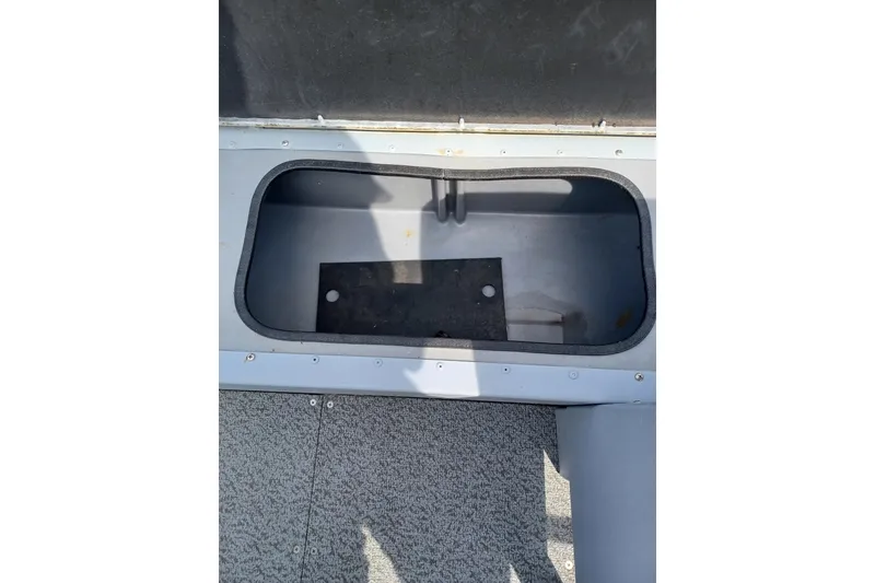 Slide: The Image of Open storage compartment in 2021 G3 Guide V150 T boat. - 14
