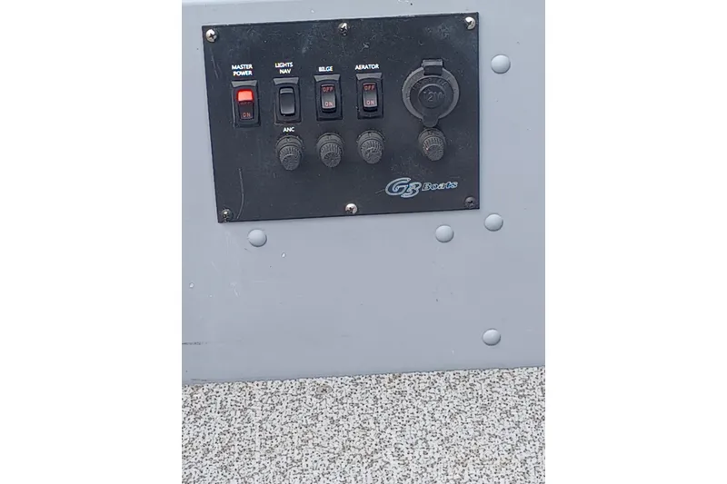 Slide: The Image of Control panel of a 2021 G3 Guide V150 T boat with switches and outlets. - 16