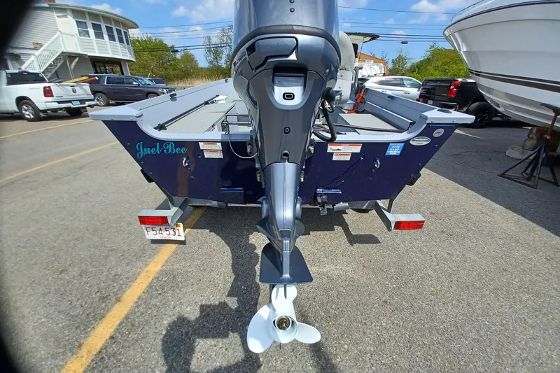 Slide: The Image of Rear view of a 2021 G3 Guide V150 T boat with motor in a parking lot. - 4