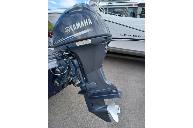 Slide: The Image of Yamaha outboard motor on G3 Guide V150 T, 2021 model, parked near a boat. - 5