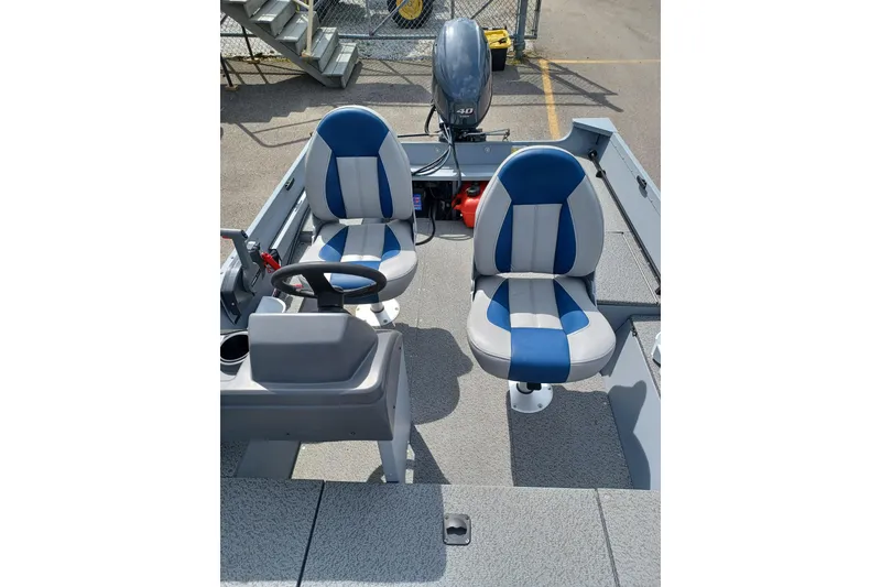 Slide: The Image of 2021 G3 Guide V150 T boat interior with blue and white seats and steering wheel. - 7