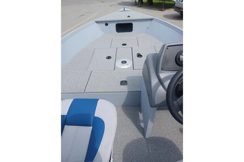 Slide: The Image of 2021 G3 Guide V150 T boat interior with gray deck and blue-accented seating. - 9