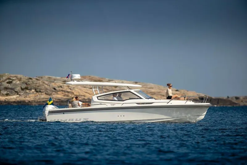 Slide: The Image of Nimbus Weekender 9 2025 cruising on the sea near rocky coastline. - 5