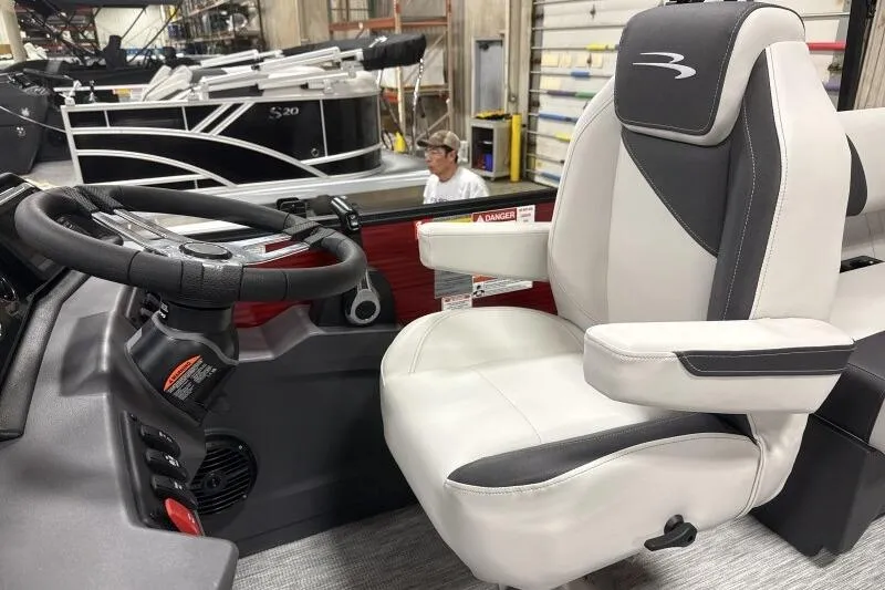 Slide: The Image of 2026 Bennington S 20 SSR boat interior with steering wheel and captain's chair. - 14