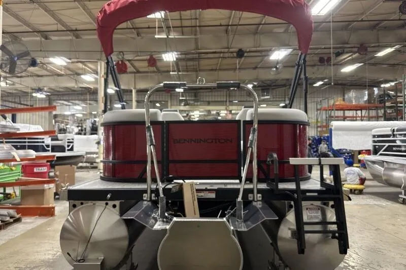 Slide: The Image of 2026 Bennington S 20 SSR pontoon boat in a factory setting, rear view. - 20