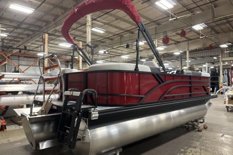 Slide: The Image of 2026 Bennington S 20 SSR pontoon boat in a warehouse setting. - 21