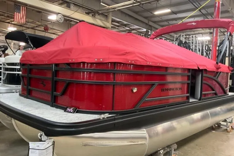 Slide: The Image of 2026 Bennington S 20 SSR pontoon boat with red cover in showroom. - 25
