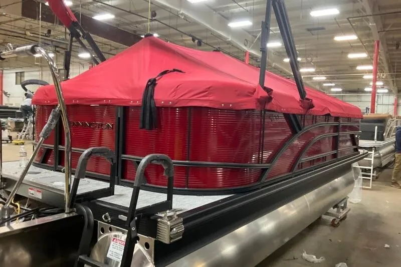 Slide: The Image of 2026 Bennington S 20 SSR pontoon boat with red canopy in a warehouse setting. - 27