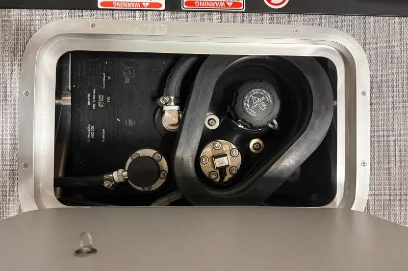 Slide: The Image of Fuel compartment of a 2026 Bennington S 20 SSR boat, showing hoses and cap. - 30