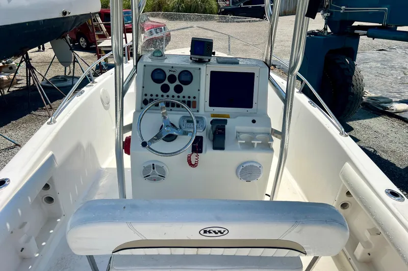 Slide: The Image of 2010 Key West 186 Sportsman boat console with steering wheel and navigation equipment. - 10