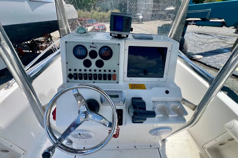 Slide: The Image of 2010 Key West 186 Sportsman boat dashboard with steering wheel and controls. - 11