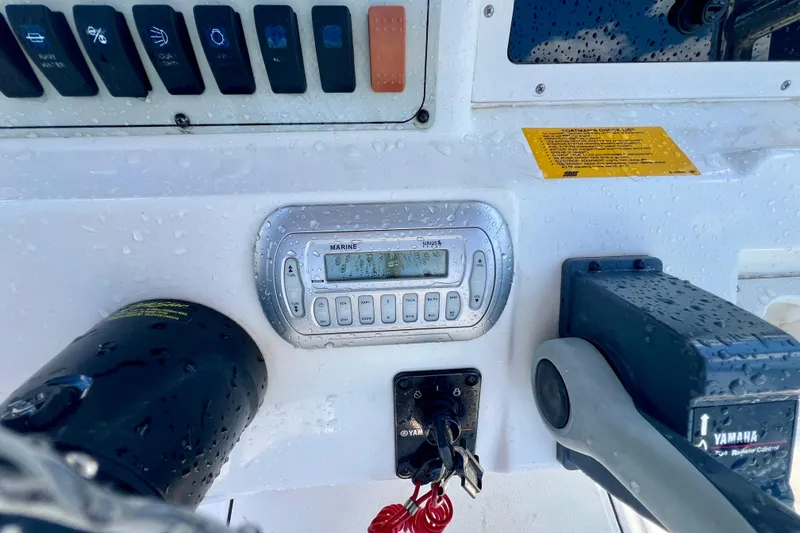 Slide: The Image of Control panel of a 2010 Key West 186 Sportsman boat with marine radio and Yamaha throttle. - 13
