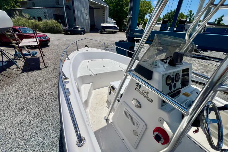 Slide: The Image of 2010 Key West 186 Sportsman boat in a marina, showcasing console and seating area. - 15
