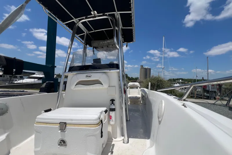 Slide: The Image of 2010 Key West 186 Sportsman boat with T-top and cooler, docked under blue sky. - 19