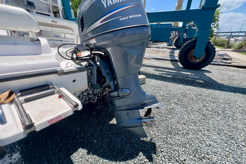Slide: The Image of 2010 Key West 186 Sportsman boat with Yamaha four-stroke outboard motor on gravel surface. - 22