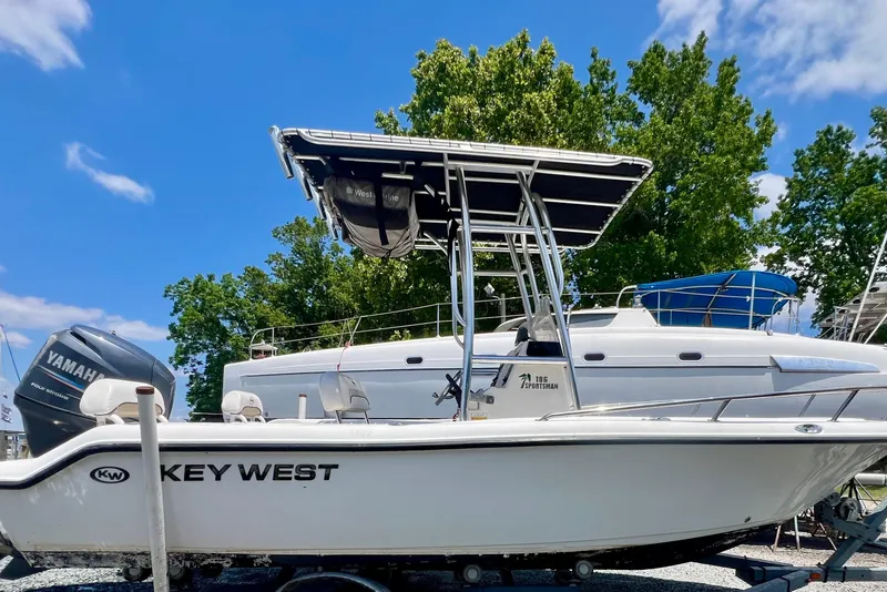Slide: The Image of 2010 Key West 186 Sportsman boat with Yamaha engine, parked outdoors under blue sky. - 4