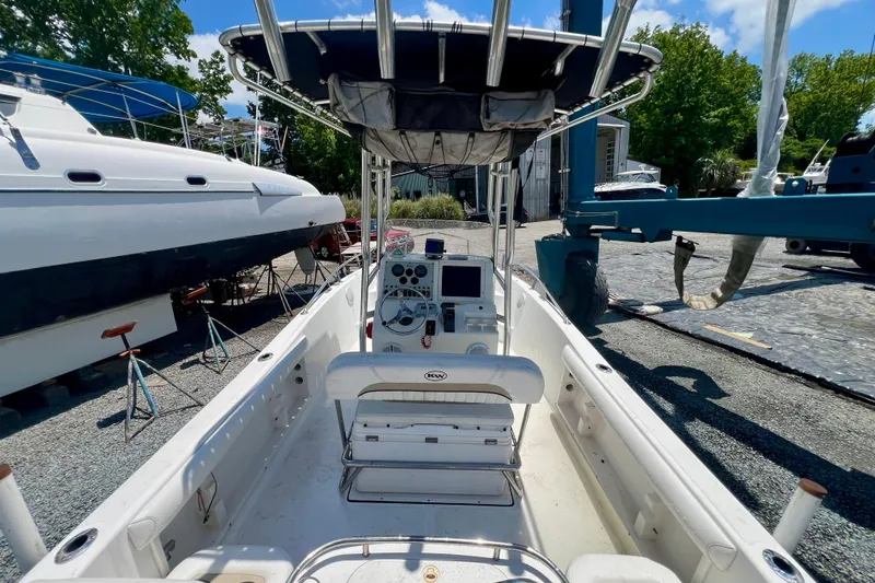 Slide: The Image of 2010 Key West 186 Sportsman boat with T-top, docked near other vessels. - 6