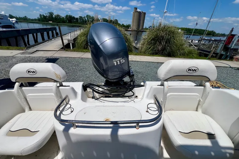 Slide: The Image of 2010 Key West 186 Sportsman boat with Yamaha 115 engine, docked by a scenic waterfront. - 8