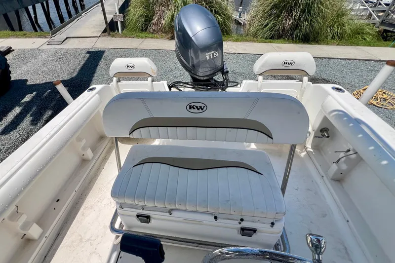 Slide: The Image of 2010 Key West 186 Sportsman boat interior with Yamaha 115 engine, featuring white seating. - 9