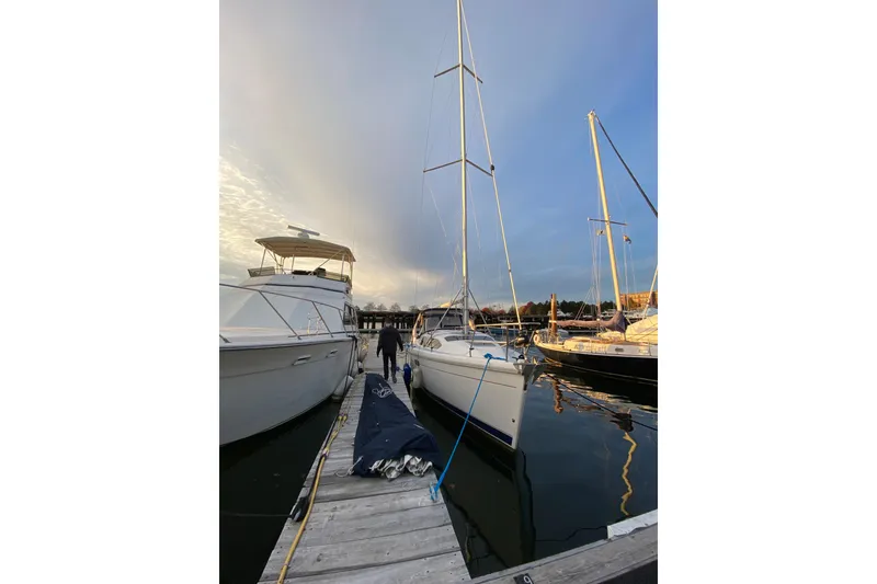 Slide: The Image of Sailboat docked at marina, Hunter 340 model, 1997, with clear sky and calm waters. - 1