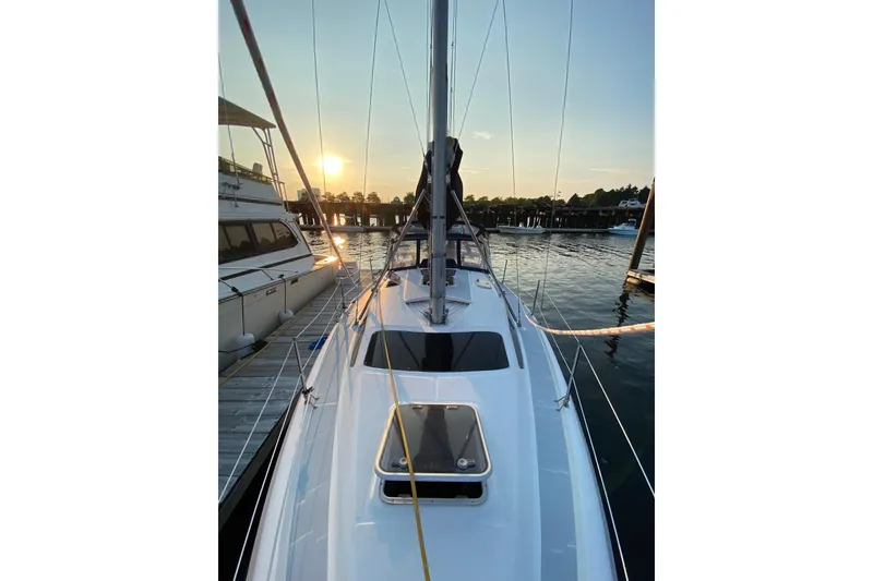 Slide: The Image of Sailboat Hunter 340, 1997 model, docked at sunset with calm waters. - 3
