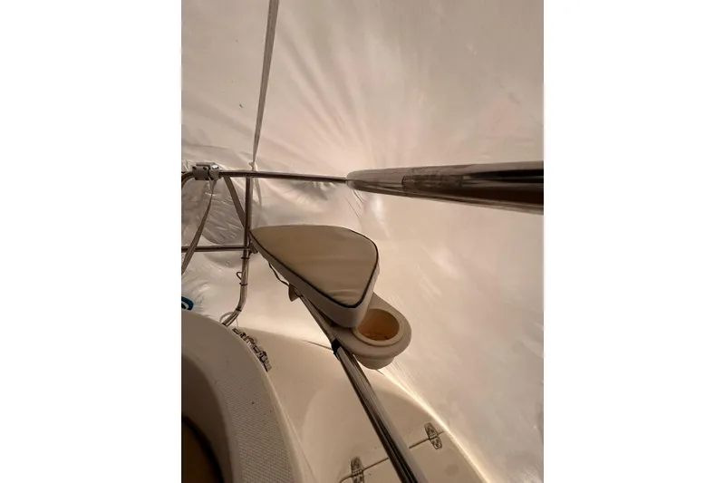 Slide: The Image of Interior view of a 1997 Hunter 340 sailboat, featuring a cushioned seat and metal railings. - 7