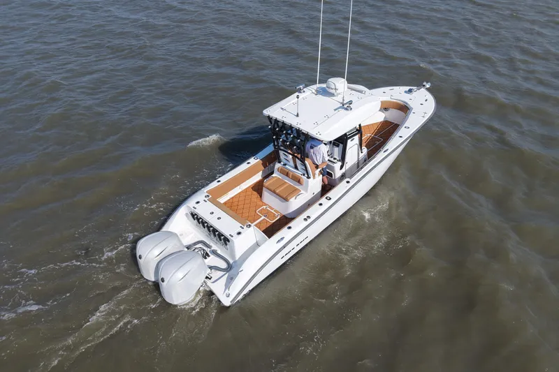 Slide: The Image of 2021 Cape Horn 32 T boat cruising on open water, featuring dual outboard engines. - 11