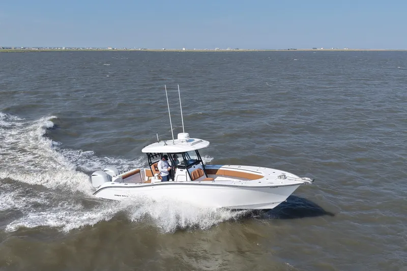 Slide: The Image of 2021 Cape Horn 32 T boat cruising on open water under clear skies. - 13