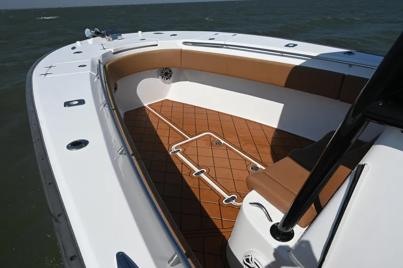 Slide: The Image of 2021 Cape Horn 32 T boat with brown seating and teak-style flooring on open water. - 21