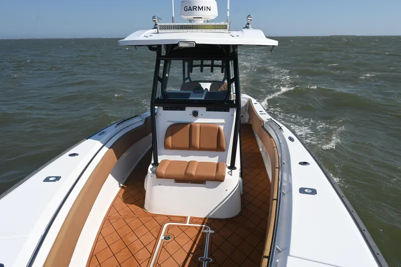 Slide: The Image of 2021 Cape Horn 32 T boat navigating through choppy waters, featuring a Garmin system. - 25