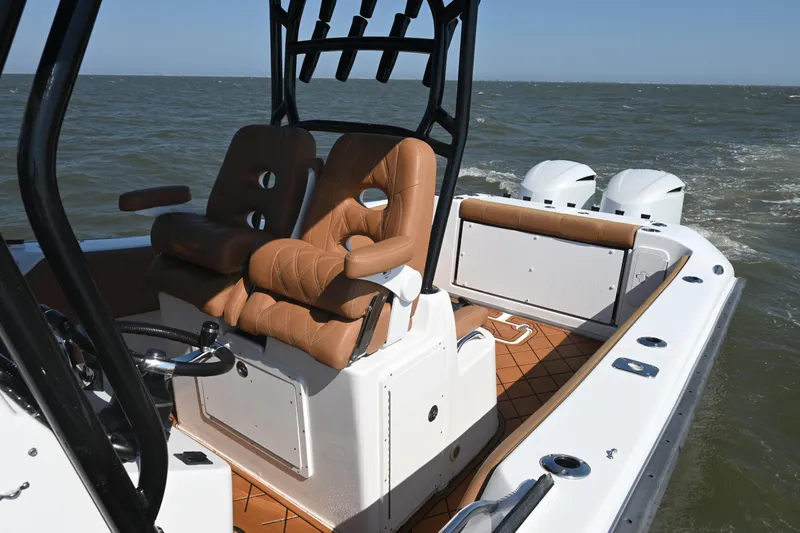 Slide: The Image of 2021 Cape Horn 32 T boat with tan seating and dual engines on open water. - 26