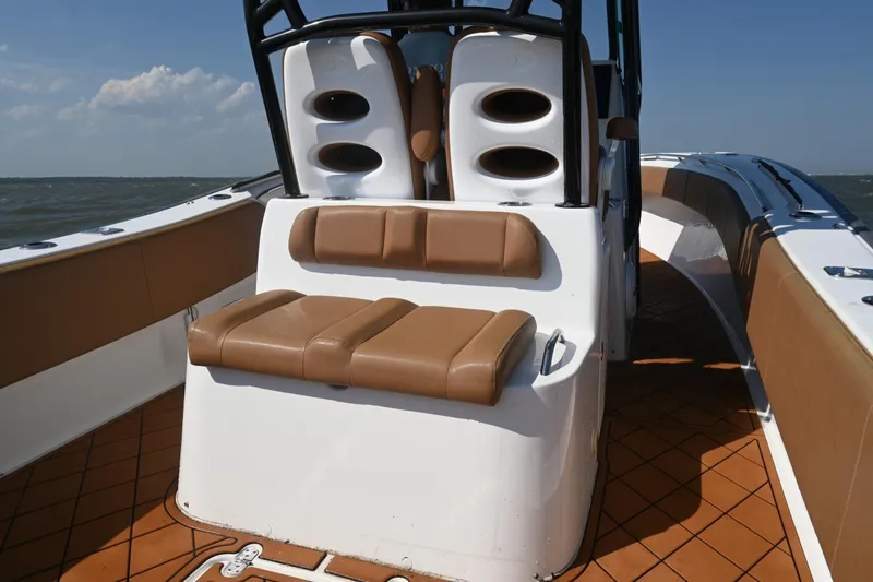 Slide: The Image of 2021 Cape Horn 32 T boat interior with tan seating and ocean backdrop. - 33