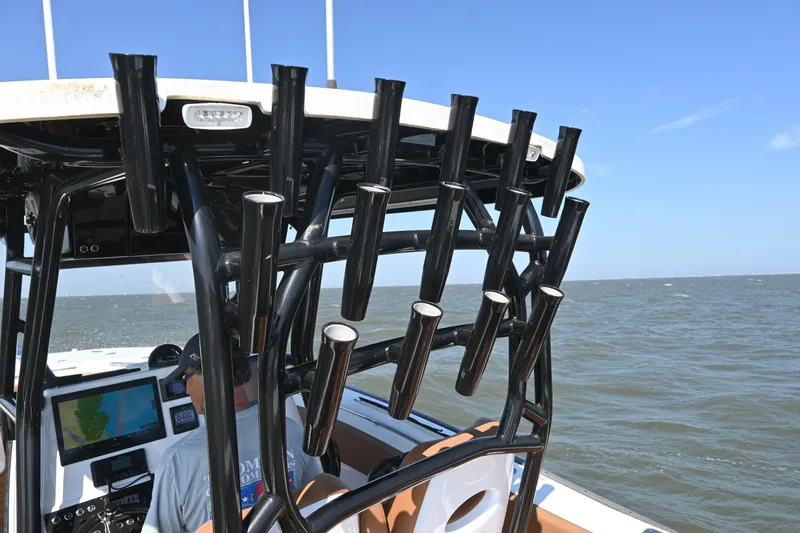 Slide: The Image of 2021 Cape Horn 32 T boat with rod holders, navigating open waters. - 34