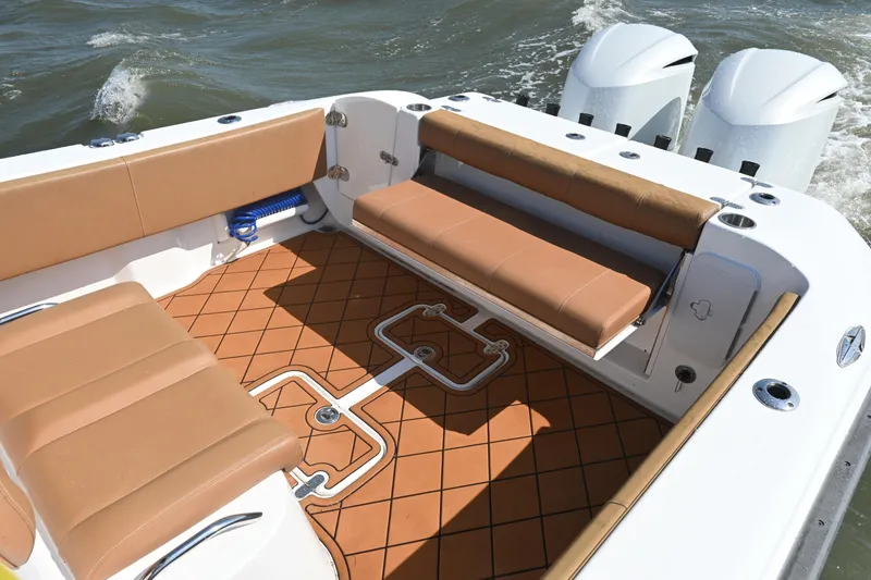 Slide: The Image of 2021 Cape Horn 32 T boat interior with tan seating and dual engines. - 36