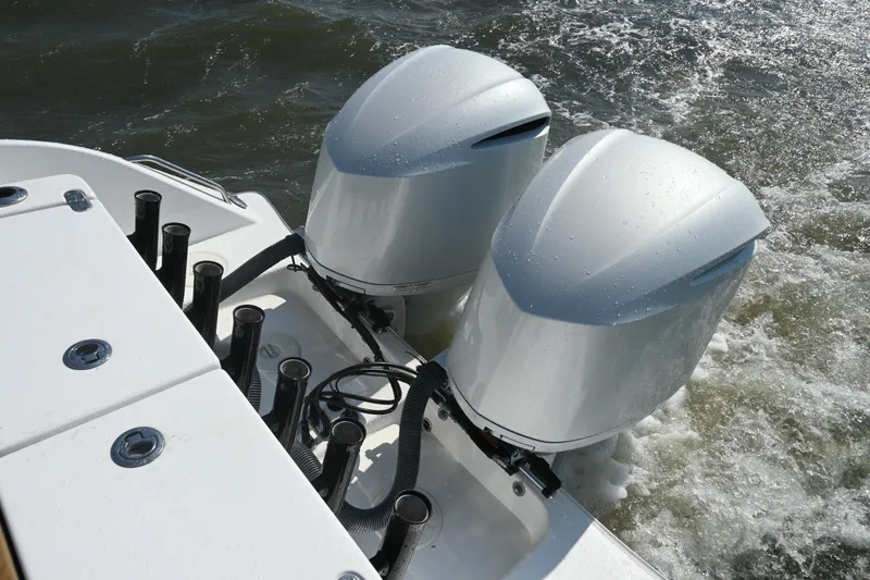 Slide: The Image of Twin outboard motors on a 2021 Cape Horn 32 T boat navigating through water. - 39
