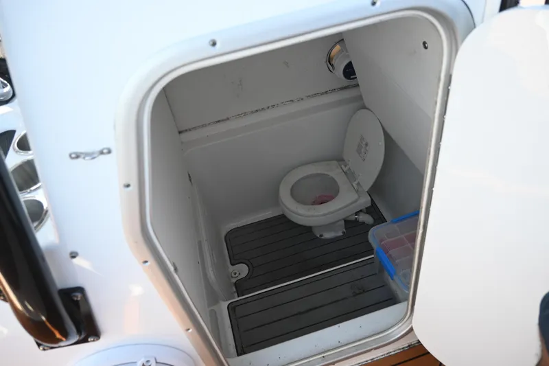 Slide: The Image of 2021 Cape Horn 32 T boat interior with compact marine toilet and storage. - 41