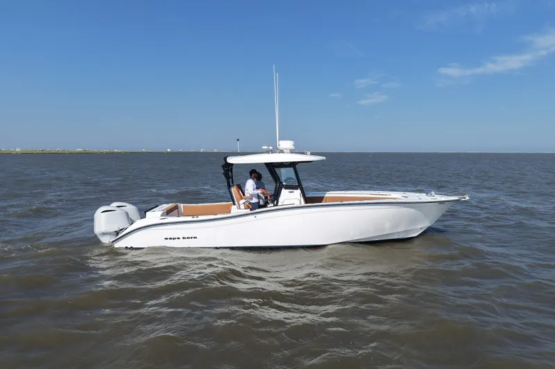 Slide: The Image of 2021 Cape Horn 32 T boat cruising on open water under clear blue skies. - 5