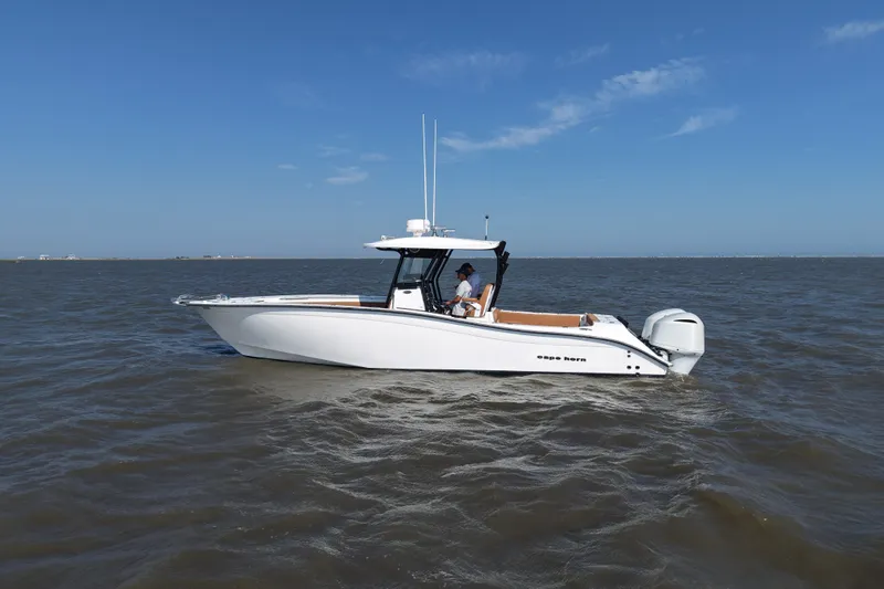 Slide: The Image of 2021 Cape Horn 32 T boat cruising on open water under clear blue skies. - 6