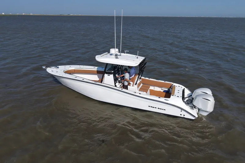 Slide: The Image of 2021 Cape Horn 32 T boat on open water, featuring dual outboard engines. - 7
