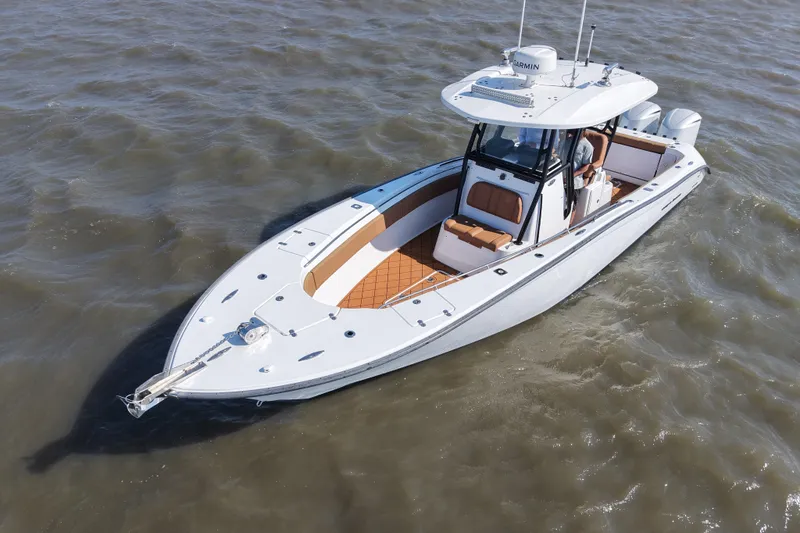 Slide: The Image of 2021 Cape Horn 32 T boat cruising on open water, showcasing sleek design and modern features. - 9