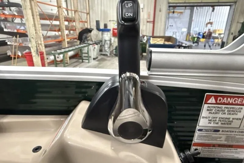 Slide: The Image of Throttle control lever on a 2026 Bennington 24 M L-Bench boat, with safety warning label. - 21
